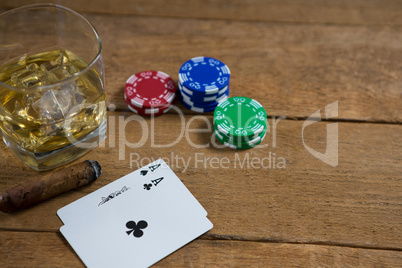 High angle view of whisky by cards and chips