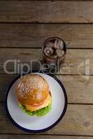 Hamburger in plate with glass of cold drink