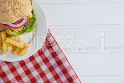 Hamburger and french fries in plate
