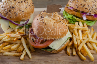 Various hamburger with tag and french fries on wooden table