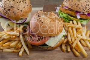 Various hamburger with tag and french fries on wooden table