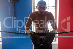 Portrait of confident man leaning on rope