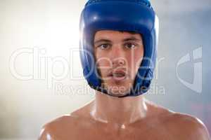 Close-up portrait of young male boxer wearing blue headgear