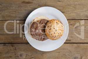 Hamburger in plate on wooden table