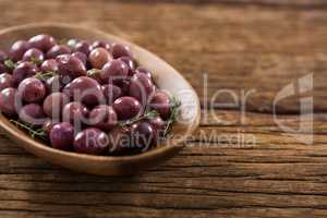 Marinated olives in wooden bowl