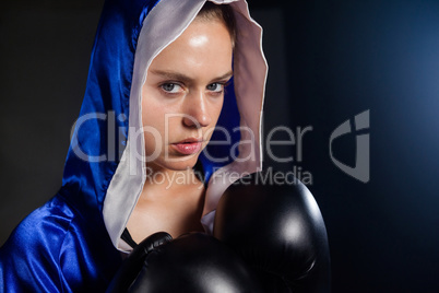 Determined woman wearing boxing gloves