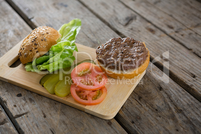 Vegetables and bun on cutting board