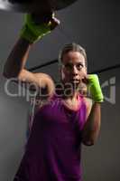 Woman practicing boxing in fitness studio