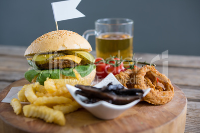 Vegetables with fried food by burger and beer