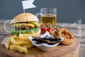 Vegetables with fried food by burger and beer