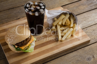 Hamburger, french fries and cold drink on table