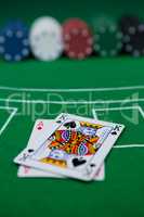 Close-up of cards and chips on blackjack table