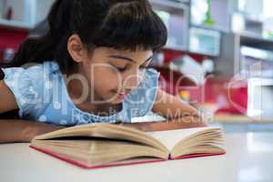 Close-up of girl reading novel in kitchen