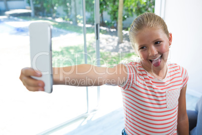 Playful girl taking selfie