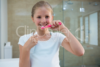 Portrait of girl brushing teeth