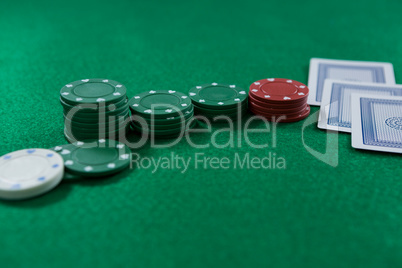 Close-up of poker chips and cards on table