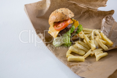 High angle view of burger and French fries on paper