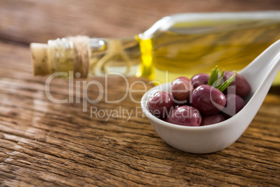 Close-up of marinated oil and olive oil bottle