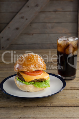 Hamburger in plate with glass of cold drink