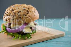 Close up of burger with cottage cheese on cutting board