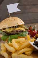 Hamburger and french fries on wooden table