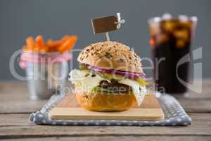 Close up of hamburger with french fries and drink in background