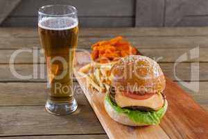 Burger and french fries with glass of beer