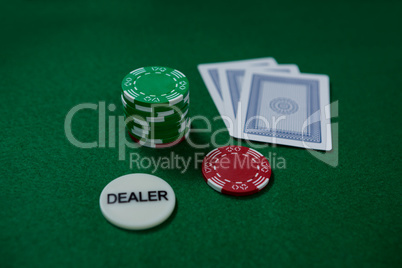 High angle view of dealer coin and chips with cards