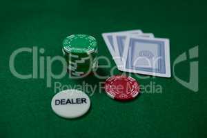 High angle view of dealer coin and chips with cards