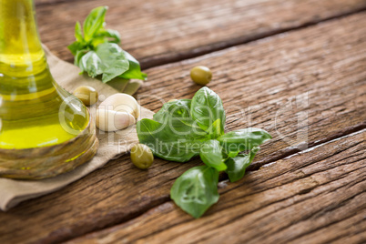 Olive oil and ingredients on wooden table