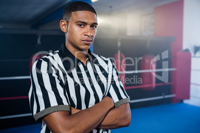 Portrait of confident male referee with arms crossed