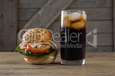 Hamburger and cold drink on table