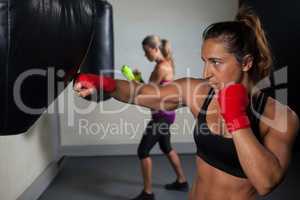 Women practicing boxing in fitness studio