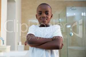 Portrait of smiling boy standing in bathroom