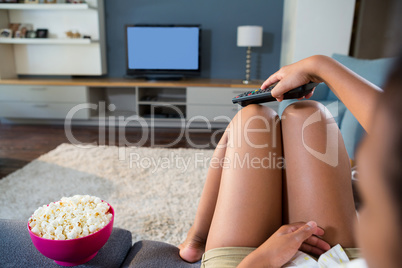 Girl watching television at home