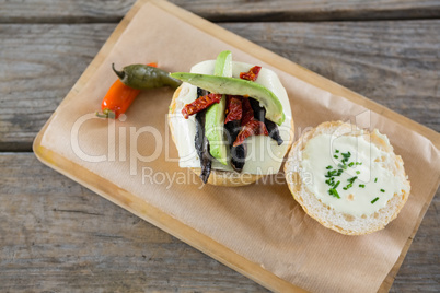 Overhead view of vegetables with cheese and bun