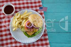 Overhead view of cheeseburger with American flag
