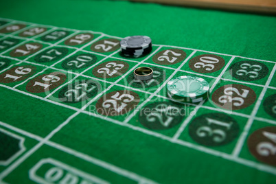 High angle view of ring and chips on roulette table