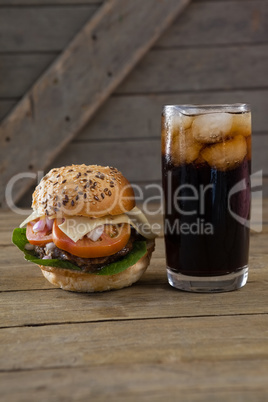 Hamburger and cold drink on table