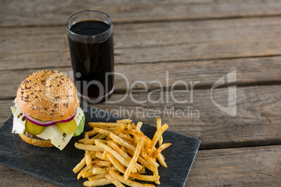 High angle view of cheeseburger with french fries and drink