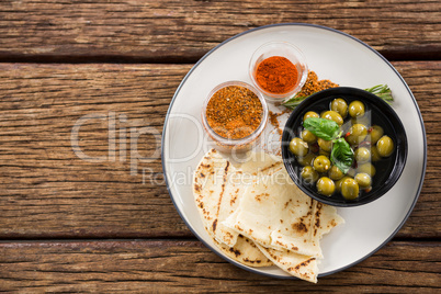 Marinated olives, food and spices on plate