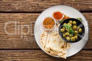 Marinated olives, food and spices on plate