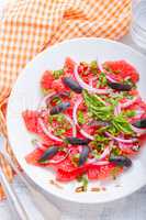 Grapefruit salad with olives, red onion, basil