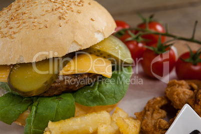 Hamburger and french fries on wooden table