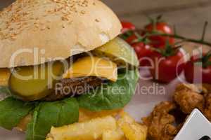 Hamburger and french fries on wooden table