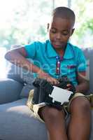 Boy adjusting virtual reality headset at home