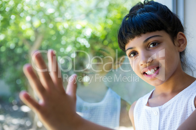 Close up of girl standing by window