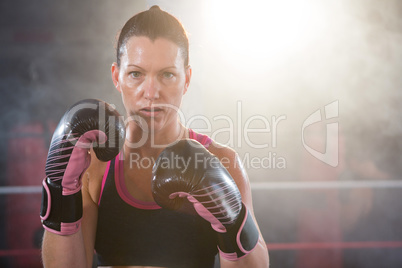 Portrait of confident young female boxer