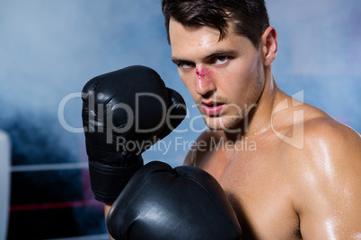 Close-up portrait of male boxer with bleeding nose