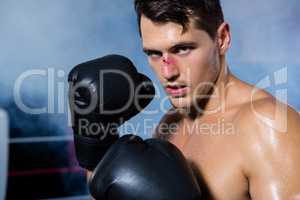 Close-up portrait of male boxer with bleeding nose